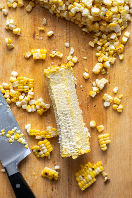 Grilled corn removed from cob with a sharp knife.