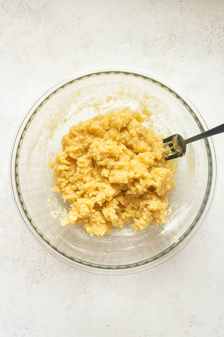 Shortbread-style peach cobbler topping prepared with melted butter.