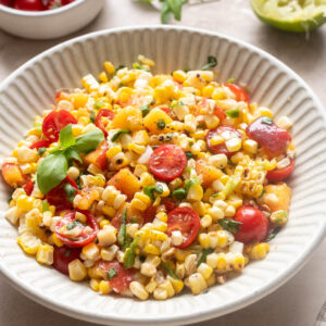 Peach tomato corn salad with grilled corn, cherry tomatoes, fresh peaches and basil.