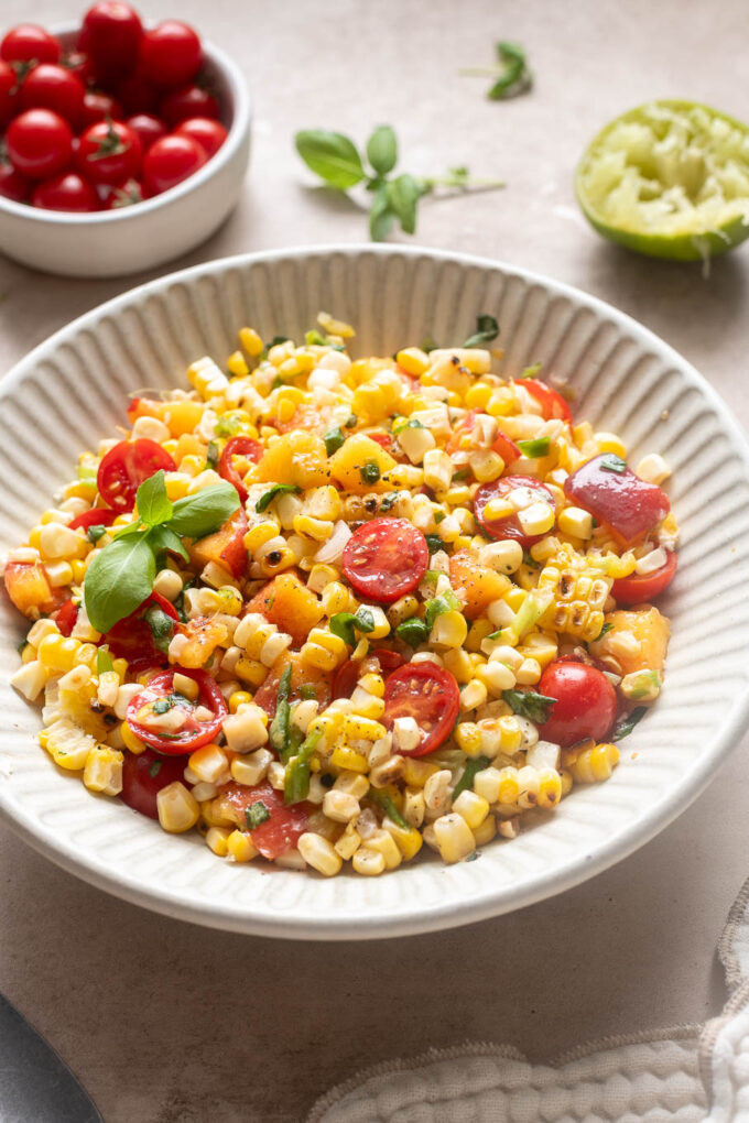 Peach tomato corn salad with grilled corn, cherry tomatoes, fresh peaches and basil.