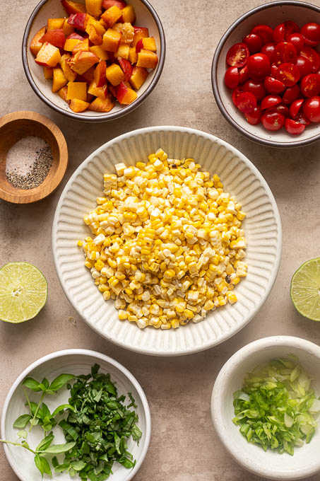 Prepped ingredients for peach tomato corn salad recipe.
