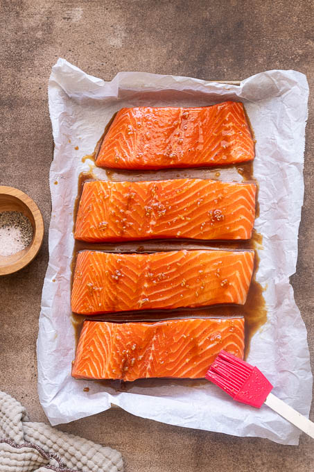 Salmon brushed with honey garlic sauce before baking.