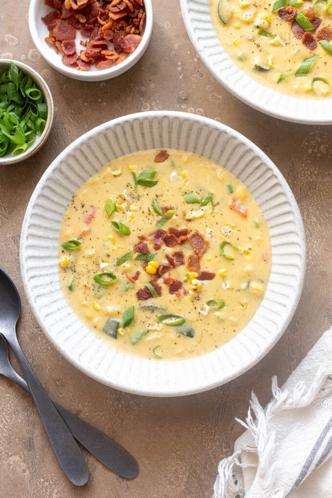 Bowl of zucchini corn chowder with bacon, fresh corn and zucchini.