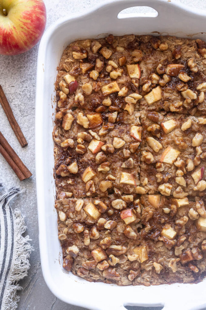 Apple baked oatmeal cut into squares in baking dish.