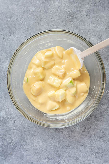 French apple cake batter with apples folded in.