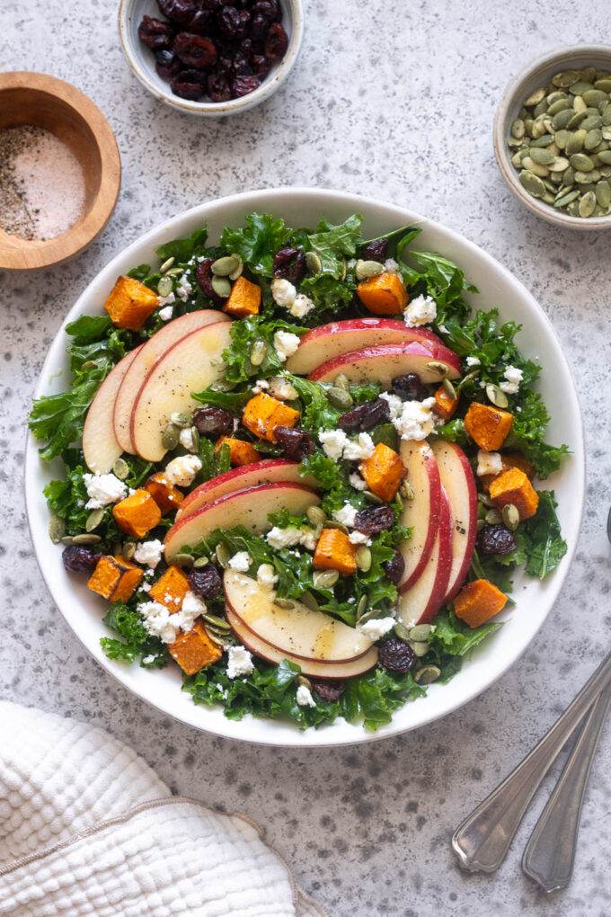 Fall harvest salad with kale, roasted butternut squash, apples, feta, cranberries and pepitas.
