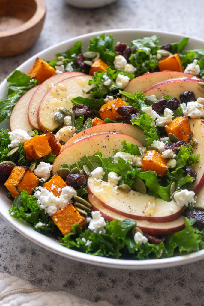 Close up of fall harvest salad with apples, roasted butternut squash, kale and feta.