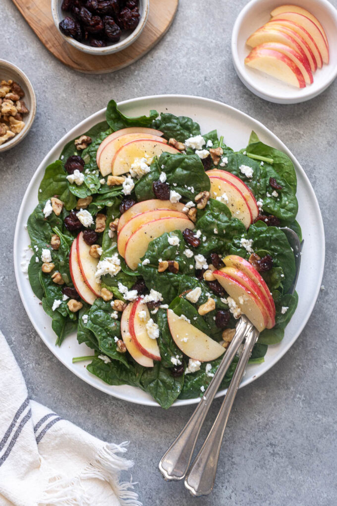 Easy spinach apple walnut salad served with apple cider dressing.