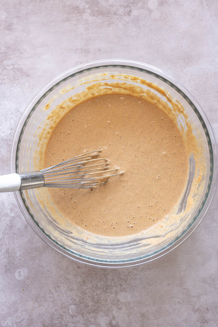 Batter for oat flour pumpkin pancakes in mixing bowl.