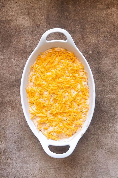 High protein buffalo chicken dip in a baking dish before baking.