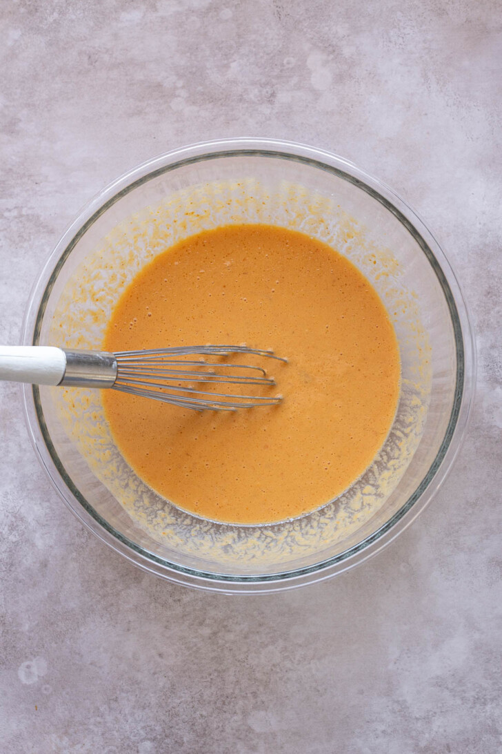 Wet ingredients for oat flour pumpkin pancakes in mixing bowl.